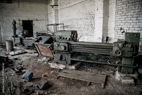 Old industrial machine tools and rusty metal equipment in abandoned factory