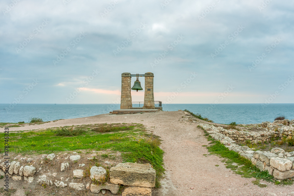 Big alarm bell. The ruins of ancient Greek city of Chersonesus Taurica in the Crimea peninsula under the cloudy sky, Sevastopol, Autumn. Scenic landscape, HDR