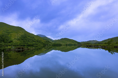 Beautiful and serene landscape of a lake and mountains in the Highlands of Scotland, United Kingdom; Concept for travel in Scotland