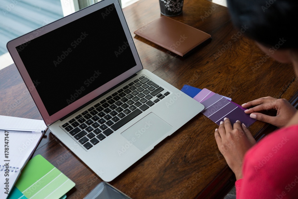Fototapeta premium Cropped image of woman arranging color swatches
