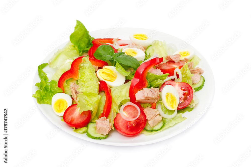 Tuna salad with lettuce, eggs and tomatoes isolated on white.