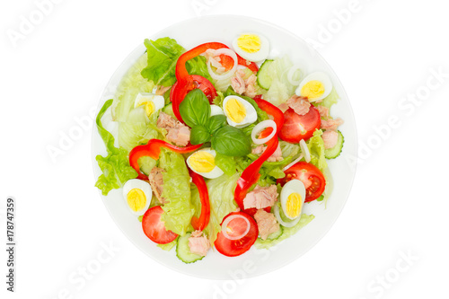 Tuna salad with lettuce, eggs and tomatoes isolated on white. Top view.