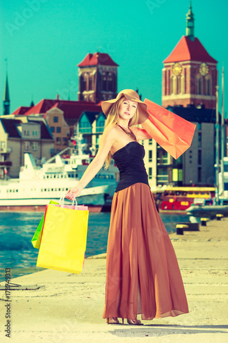 Fashionable woman walking with shopping bags