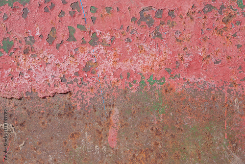 surface of rusty iron with remnants of old paint, red texture, background