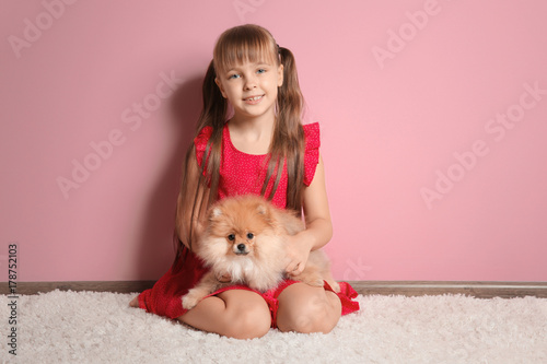 Cute girl with little dog a...