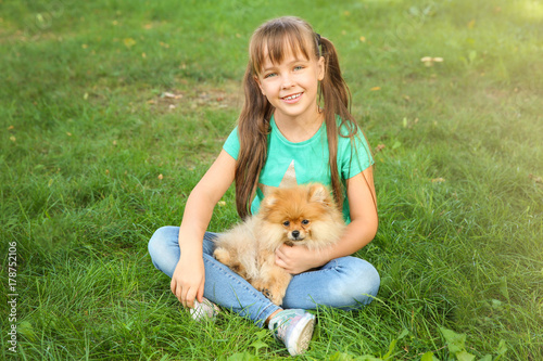 Cute girl with little dog o...