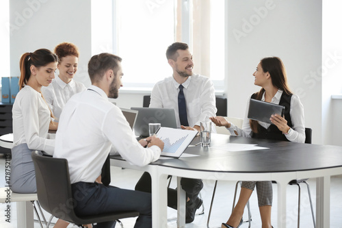 Team of young professionals conducting business meeting in office