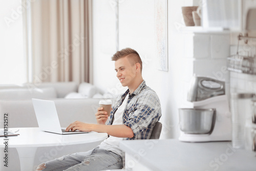 Young man working on laptop...