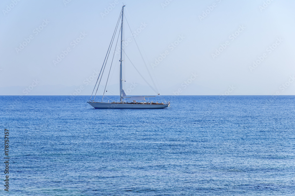 Beautiful view at natural blue sea with luxury docked travel boat on the sea on summer clear day
