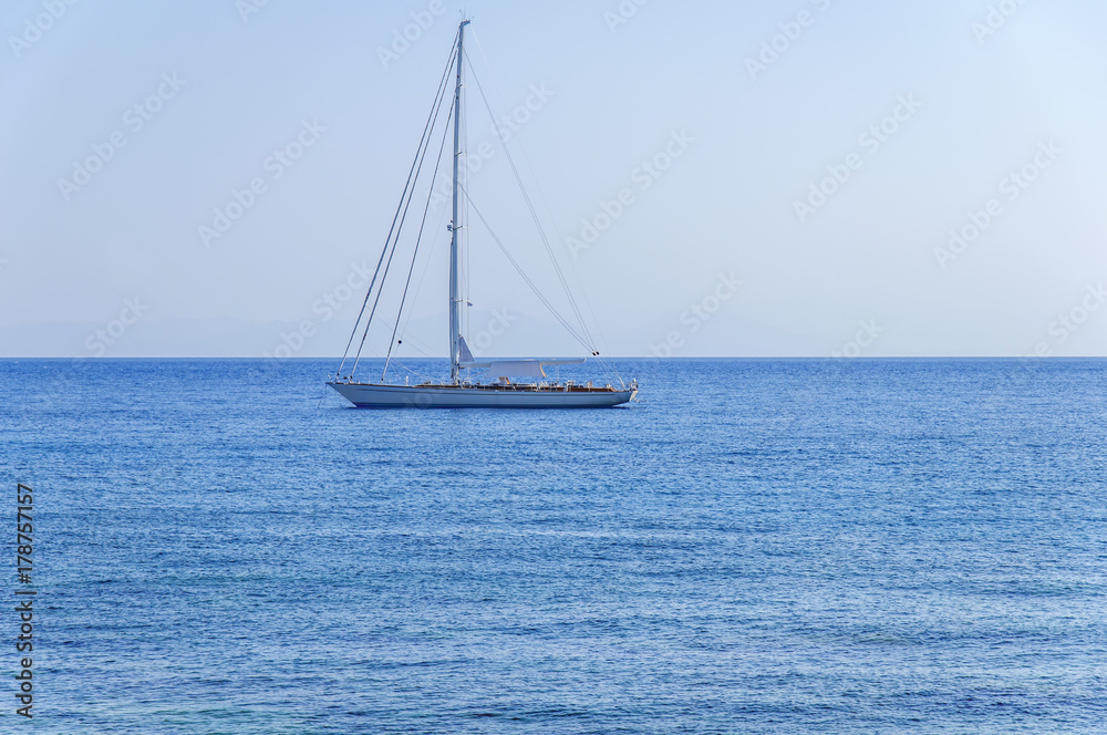 Obraz premium Beautiful view at natural blue sea with luxury docked travel boat on the sea on summer clear day