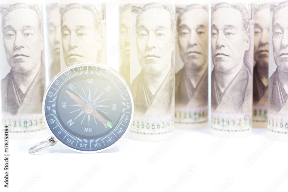 Compass On Roll Of Yen Banknote, Concept And Idea Of Direction And Money, Business And Finance Concepts, Money market in Asian Compass On Roll Of Yen Banknote, Concept And Idea Of Direction And Money, Business And Finance Concepts, Money market in Asian