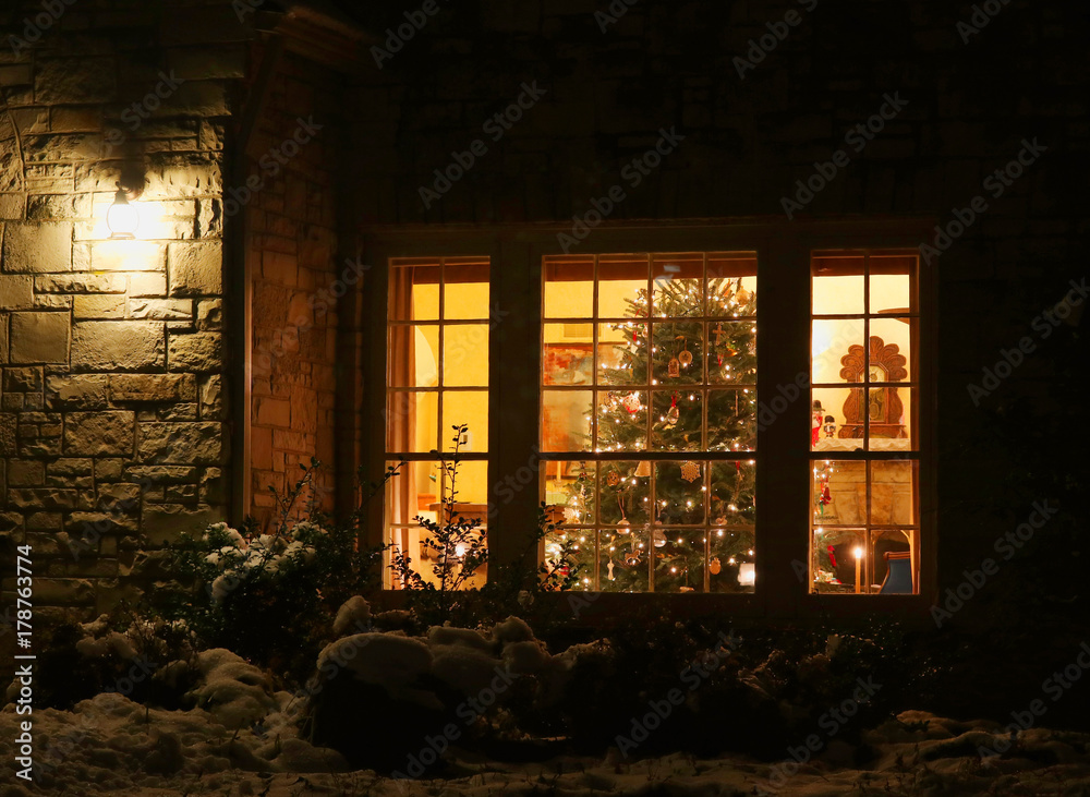 Welcome home Christmas  close up view of old style brick house  window with decorated and glowing christmas tree. Night scene. Christmas  and New Year holiday background. Stock Photo | Adobe Stock
