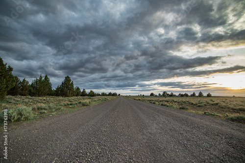 Dramatic empty gravel road into the unknown