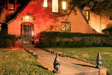 The house is decorated for Halloween: rats, spiders, shadows, gnomes. Board-plated window