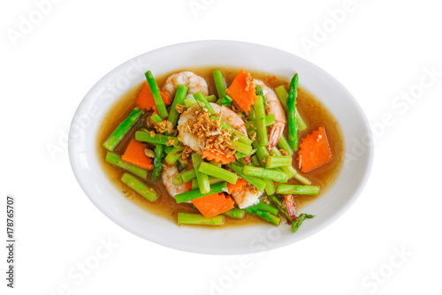 stir fried asparagus and carrot with shrimp on white plate isolated on white background with clipping path