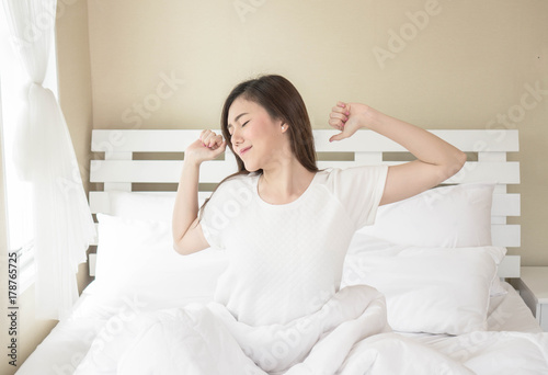 woman stretching her arm with lazy after she's waking up
