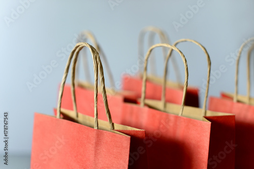 Red shopping bags from recycle paper isolated on white background. Black friday or Christmas sales.