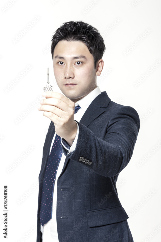 asian business man hand hold a key isolated white.