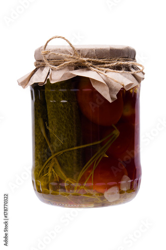 salted cucumbers and tomatoes, in a glass jar closed with a lid