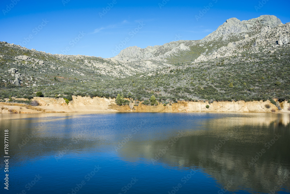 Views of La Maliciosa Reservoir, in Guadarrama Mountains (Madrid, Spain), with La Maliciosa peak in the background.