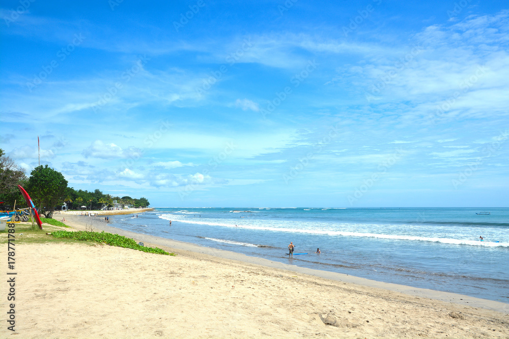 Kuta Beach in Bali, Indonesia. Famous beach with blue skies and white sands.