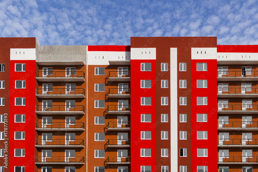 Apartment building under construction. Residential building brightly painted