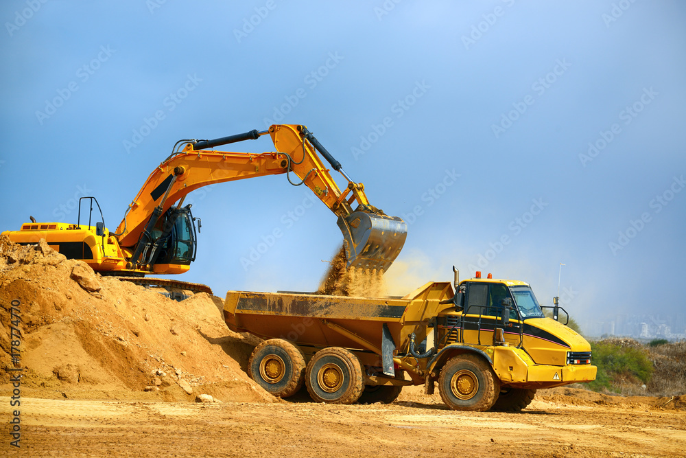 Earthmover loads the ground in the truck Earthmover loads the ground in the truck