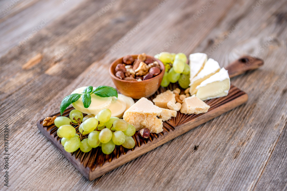 Cheese plate served with nuts and honey
