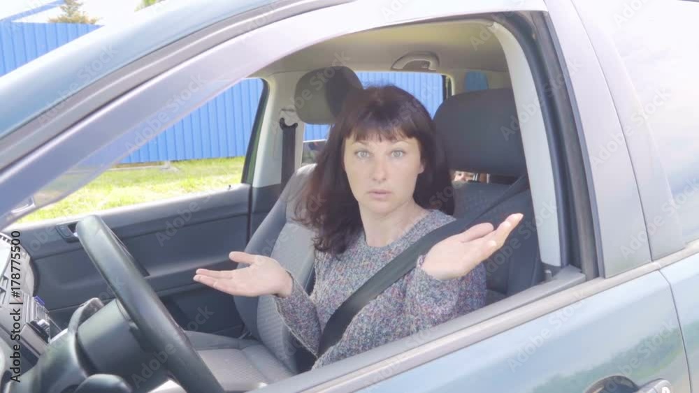 Young angry woman in perplexity sitting in the car.Slow Motion. Young angry woman in perplexity sitting in the car.Slow Motion.