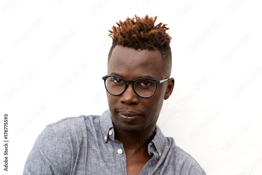 Fototapeta premium Close up serious african man with glasses against white background