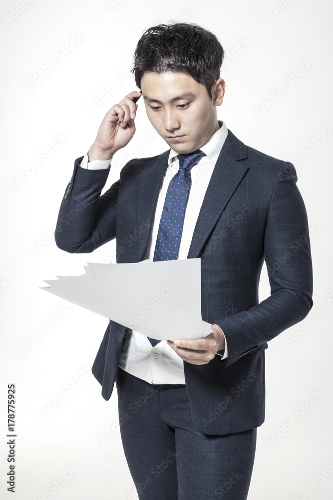 business man standing up with paper, pencil at the studio business man standing up with paper, pencil at the studio