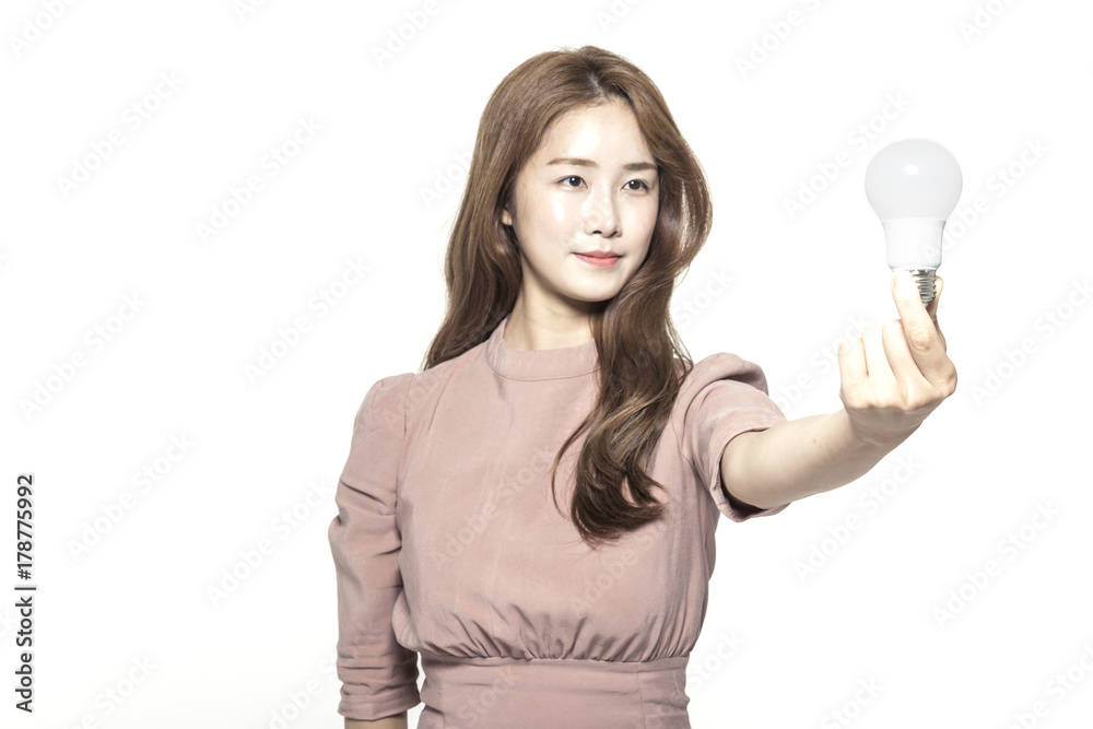 business woman standing up with a bulb at the studio business woman standing up with a bulb at the studio