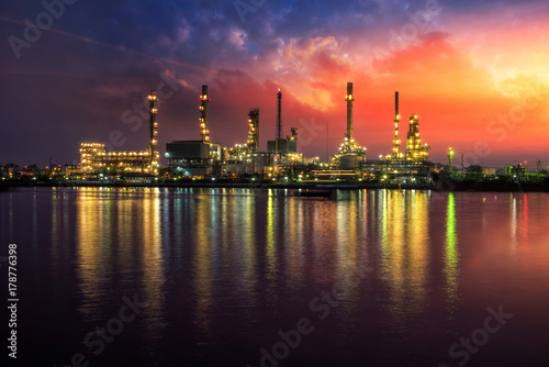 Oil and gas industry - refinery at Sunrise - factory - petrochemical plant with reflection over the river