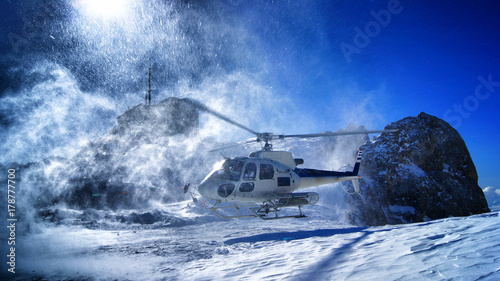 helicopter landing to pick up skiers photo