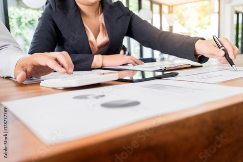 Administrator business man financial inspector and secretary making report, calculating balance. Internal Revenue Service checking document. Audit concept.