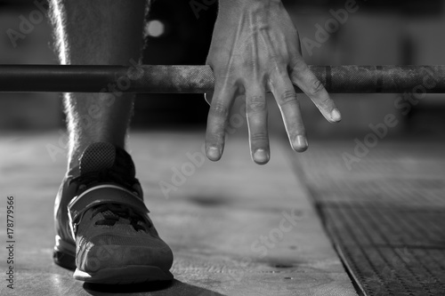 Male hand holding barbell before training