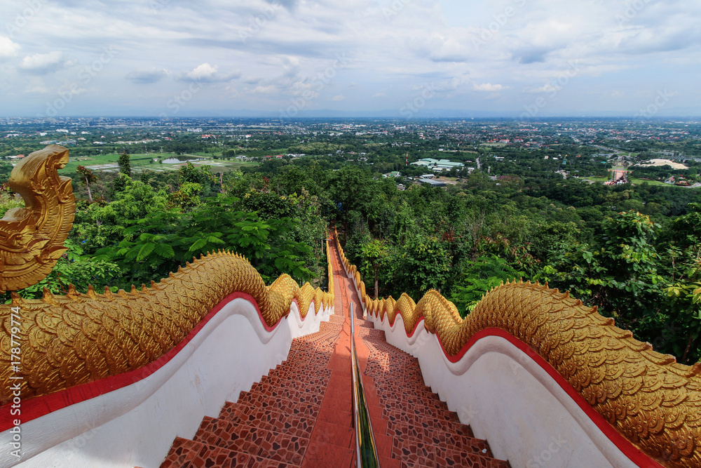 The Naga stairway down from Wat Phra That DoiKham buddhist temple in Chiang Mai, Thailand with panoramic view of Chiangmai cityscape. - obrazy, fototapety, plakaty 