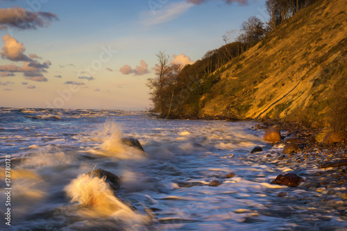 Wolin Island, Poland.Sunset over the sea during the storm, waves crashing against the stones © Mike Mareen