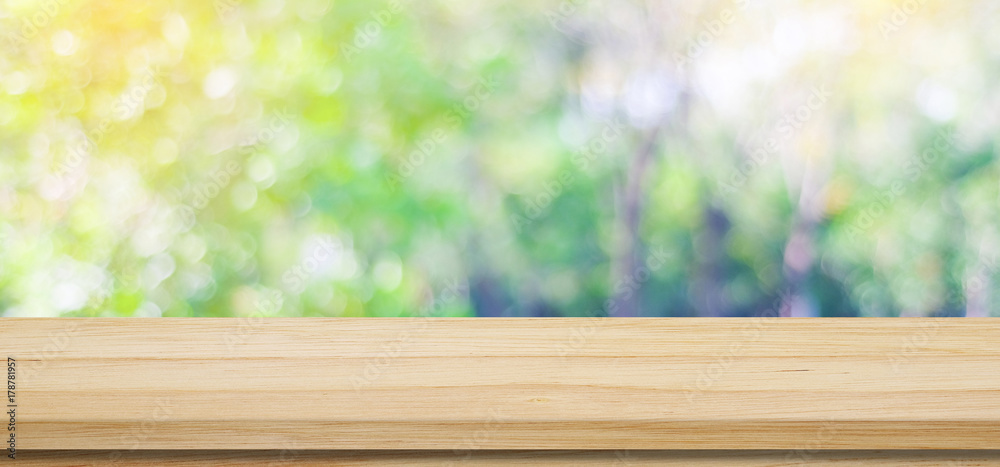 Empty wooden table over blurred tree with bokeh background, for product display montage, fall, autumn season Empty wooden table over blurred tree with bokeh background, for product display montage, fall, autumn season