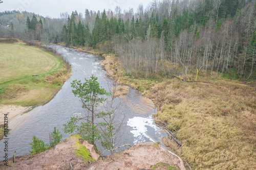 River Amta, autumn, red rocks, wood, Latvia. 2017 photo