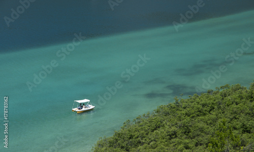 Fototapeta Naklejka Na Ścianę i Meble -  Catamaran boat sailing in turquoise water. View from above