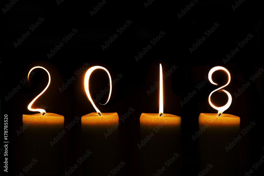 Fotografie 2018 written with candle flames on black background