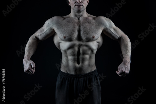 Athlete showing fit torso, abs, six pack, belly, chest, arms