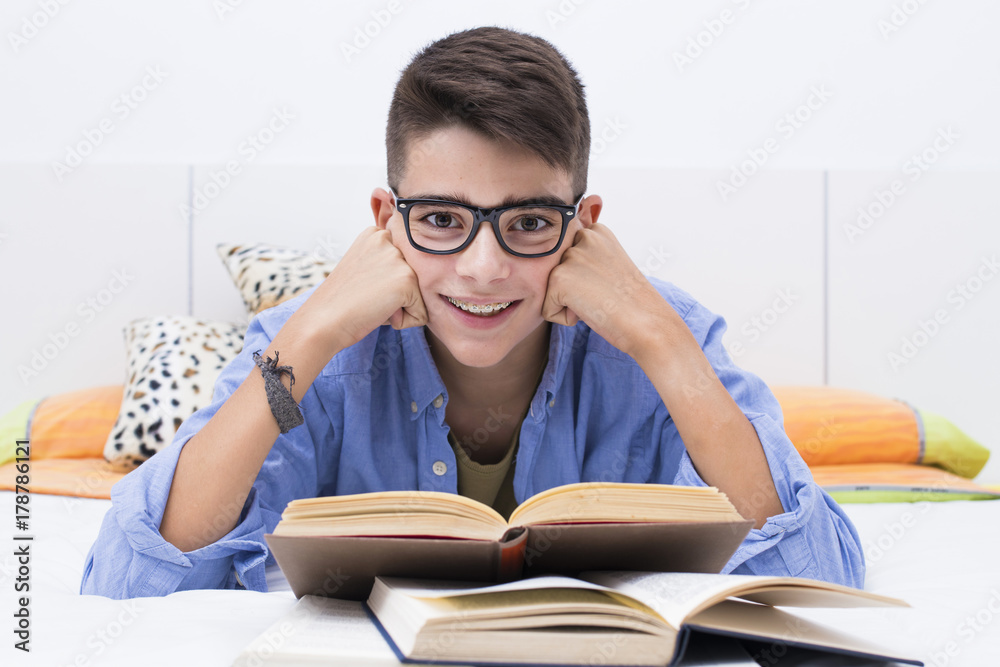preadolescent child studying with books in the home room preadolescent child studying with books in the home room