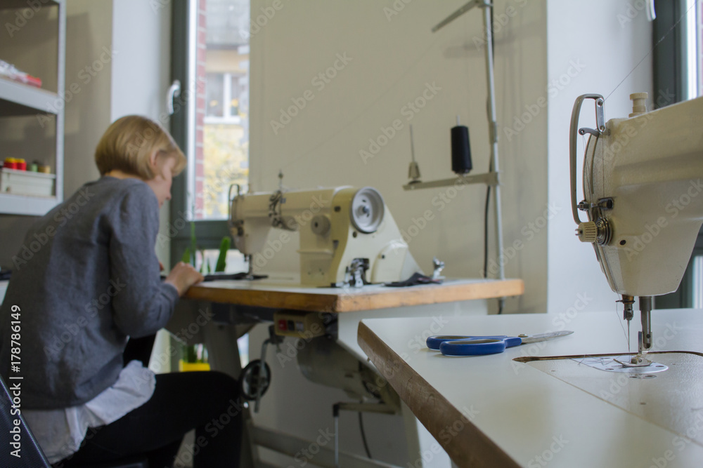 female tailors working at the sewing machine in studio   