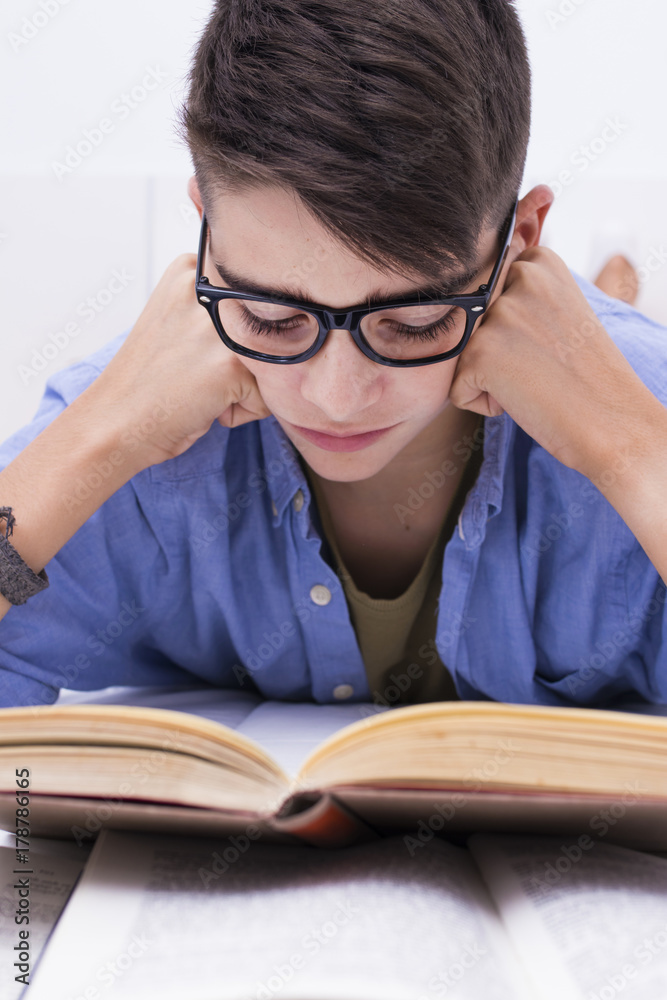 preadolescent child studying with books in the home room preadolescent child studying with books in the home room