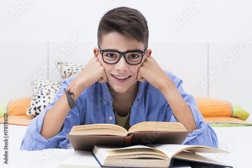 preadolescent child studying with books in the home room