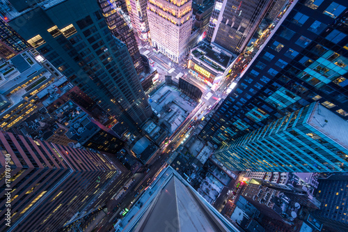 Bird's eye view of Manhattan, looking down at people and yellow taxi cabs goi...