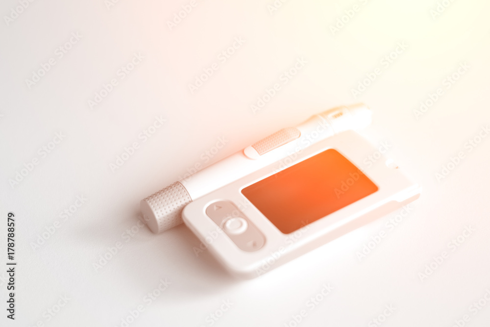 Medicine, diabetes, glycemia, health care and people concept - Glucose meter and lancet device for the diagnosis of glucose Medicine, diabetes, glycemia, health care and people concept - Glucose meter and lancet device for the diagnosis of glucose