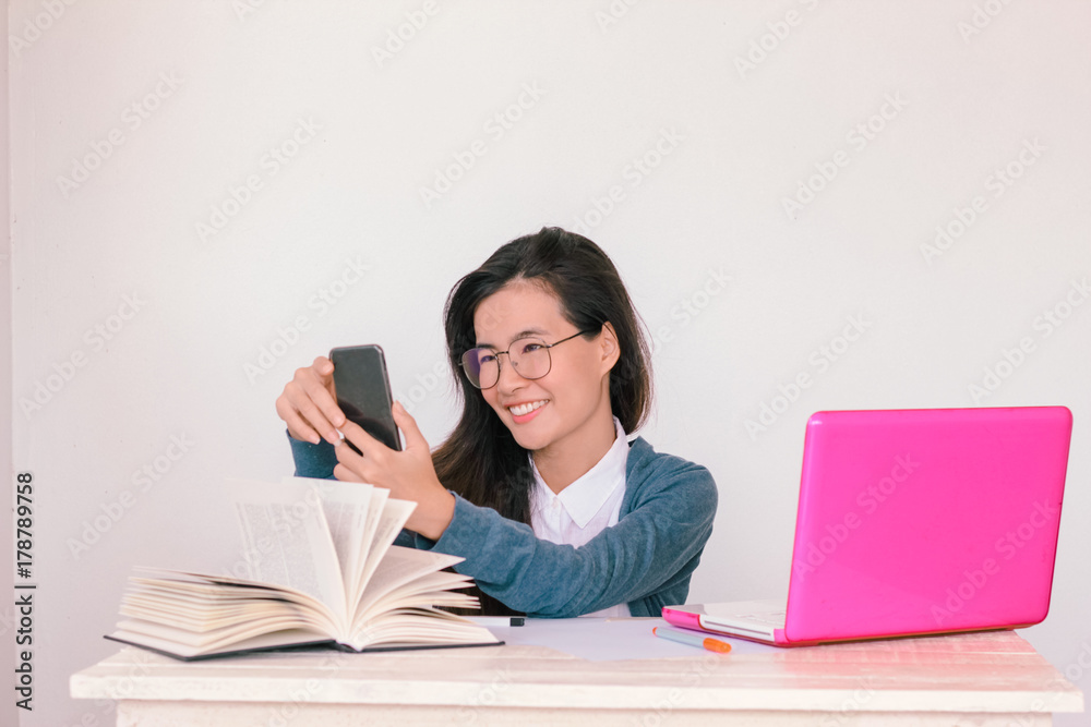 Young asian business woman wearing glasses talking on phone with copy space background - Vintage Light Effect added Young asian business woman wearing glasses talking on phone with copy space background - Vintage Light Effect added